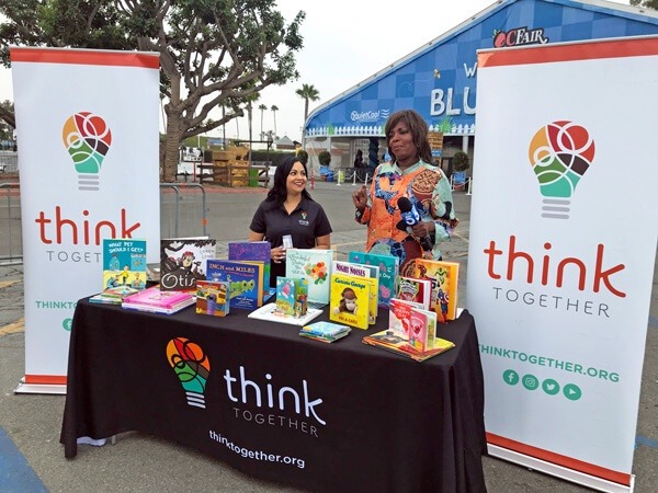 Women at a book stand at the We Care Wednesday – OC Fair event